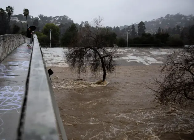 The swirling Los Angeles River on Monday.Credit...Jenna Schoenefeld for The New York Times